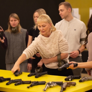 Birthday girl picking guns to shoot