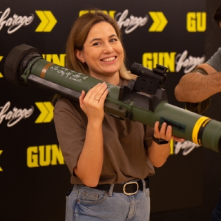 Female holding rocket launcher